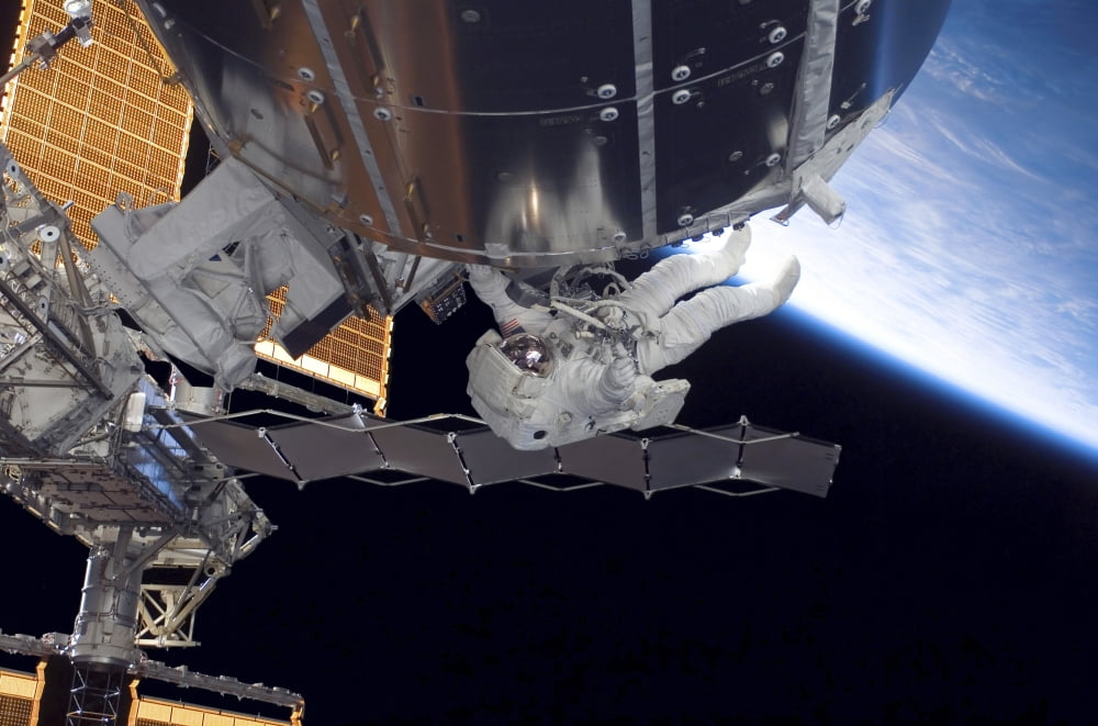 Astronaut participates in extravehicular activity Canvas Art - Stocktrek Images (34 x 23)