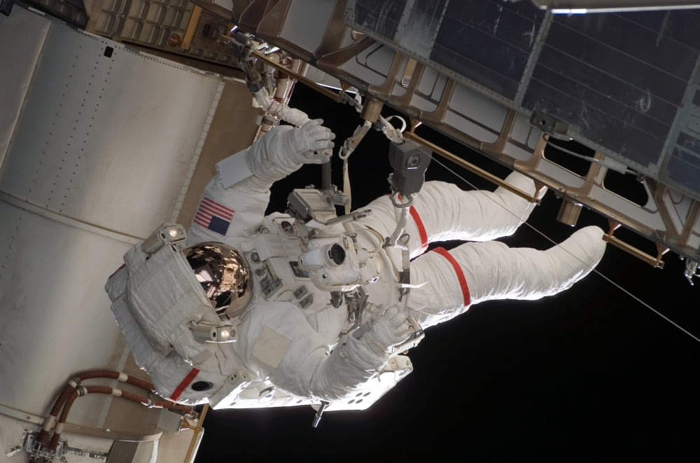 Astronaut participates in extravehicular activity Canvas Art - Stocktrek Images (34 x 23)