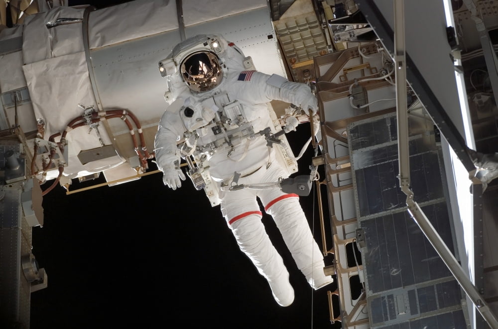 Astronaut participates in extravehicular activity Canvas Art - Stocktrek Images (34 x 23)