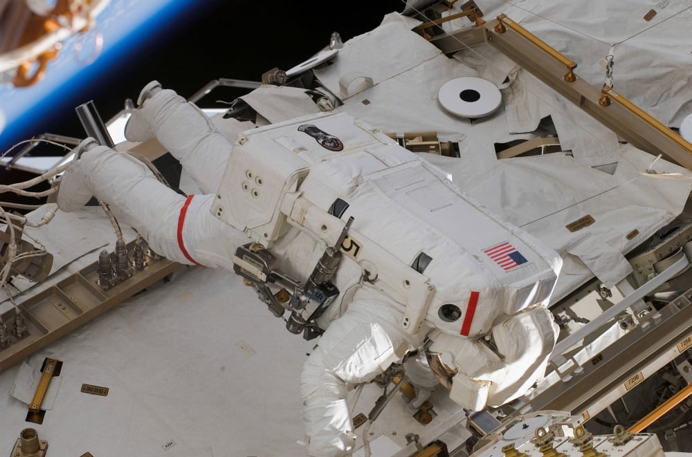 Astronaut participates in extravehicular activity Canvas Art - Stocktrek Images (34 x 23)