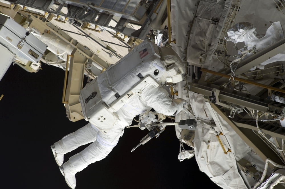 Astronaut participates in extravehicular activity Canvas Art - Stocktrek Images (34 x 23)