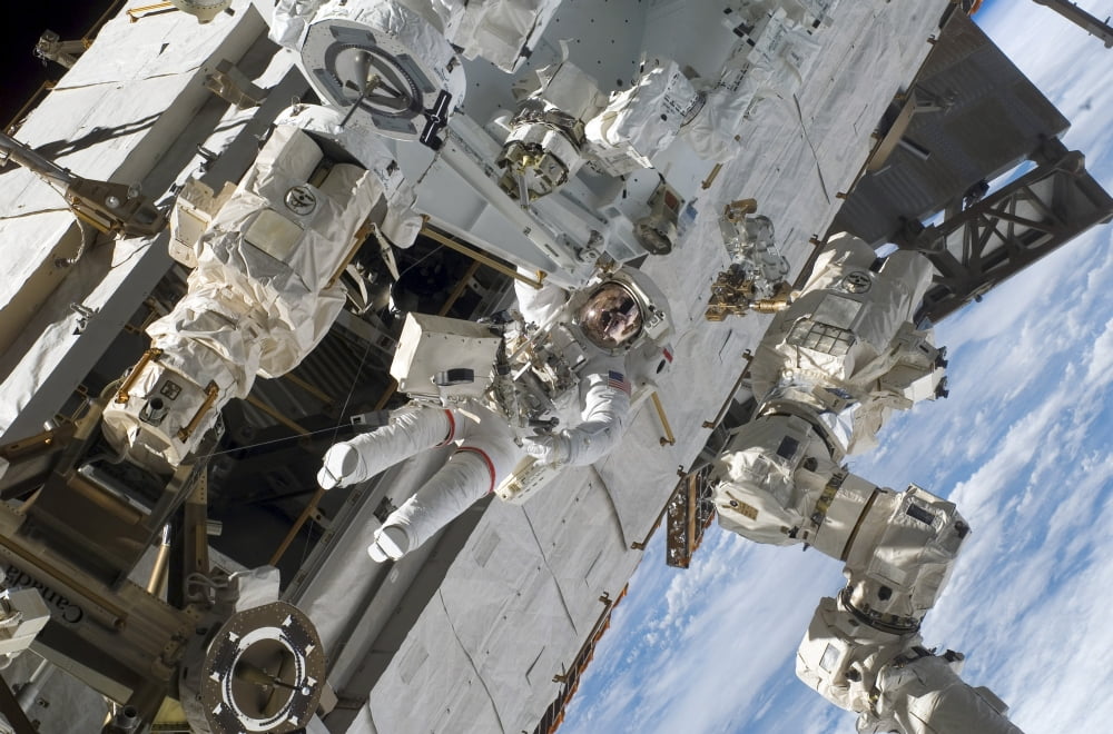Astronaut participates in extravehicular activity Canvas Art - Stocktrek Images (34 x 23)