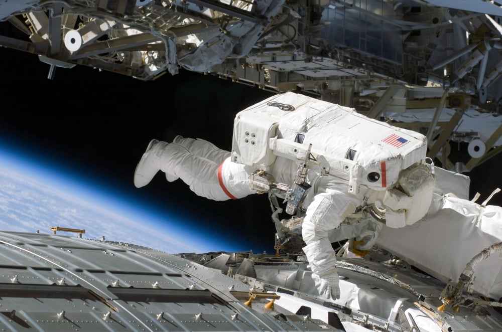 Astronaut participates in extravehicular activity Canvas Art - Stocktrek Images (34 x 23)