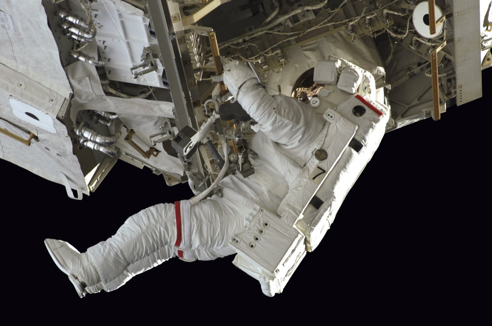 Astronaut participates in extravehicular activity Canvas Art - Stocktrek Images (34 x 23)