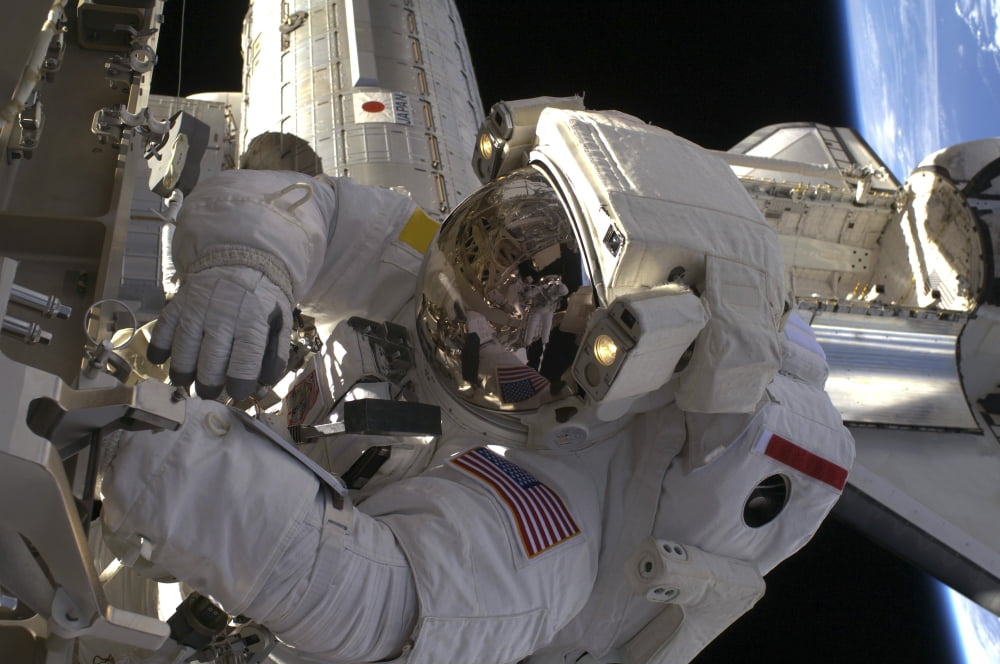 Astronaut participates in extravehicular activity Canvas Art - Stocktrek Images (34 x 23)