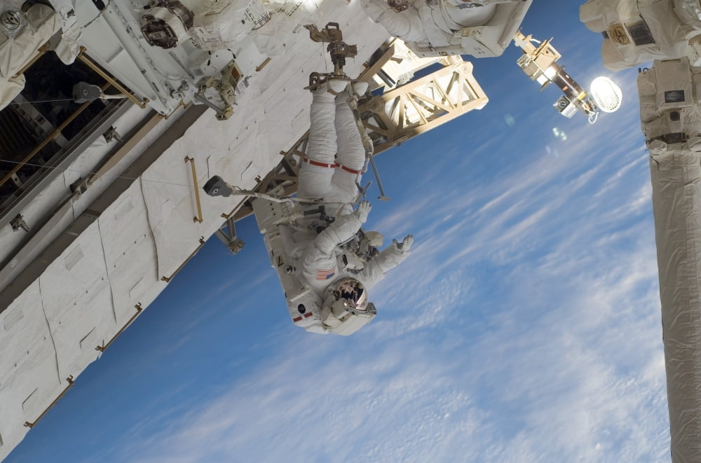 Astronaut participates in extravehicular activity Canvas Art - Stocktrek Images (34 x 23)