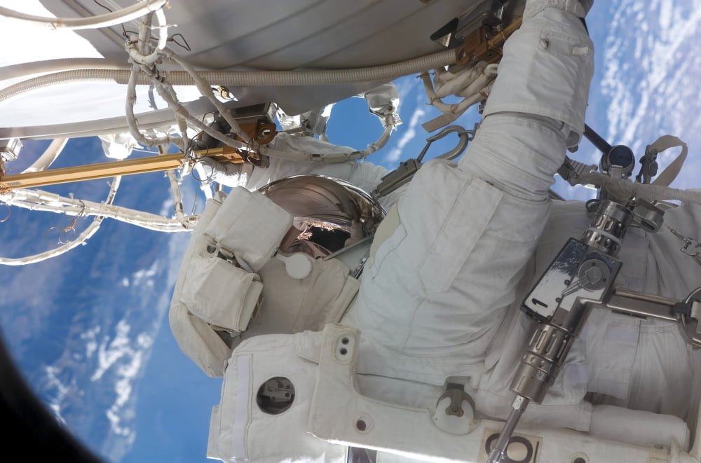 Astronaut participates in extravehicular activity Canvas Art - Stocktrek Images (34 x 23)