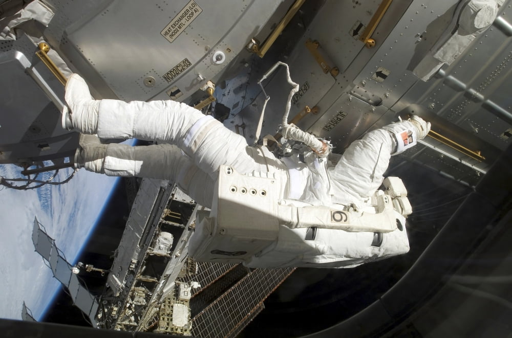 Astronaut participates in extravehicular activity Canvas Art - Stocktrek Images (34 x 23)