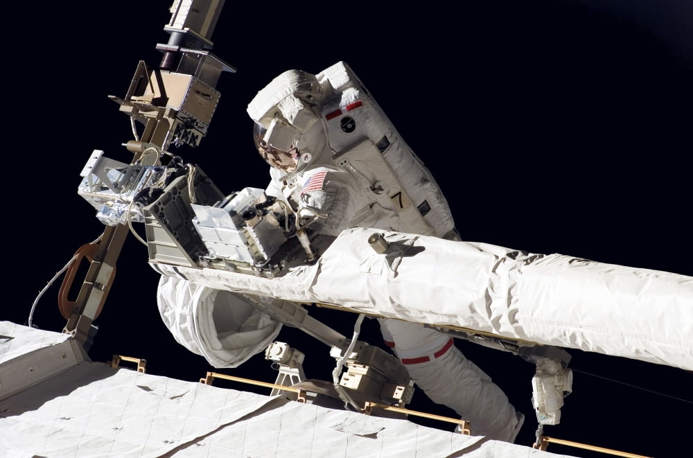 Astronaut participates in extravehicular activity Canvas Art - Stocktrek Images (34 x 23)