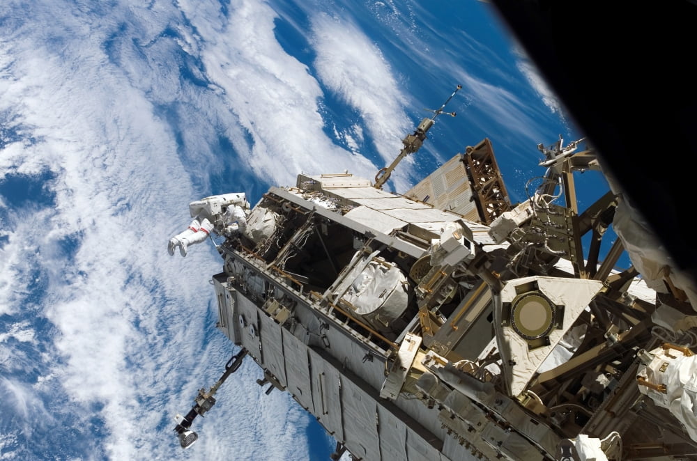 Astronaut participates in extravehicular activity Canvas Art - Stocktrek Images (34 x 23)