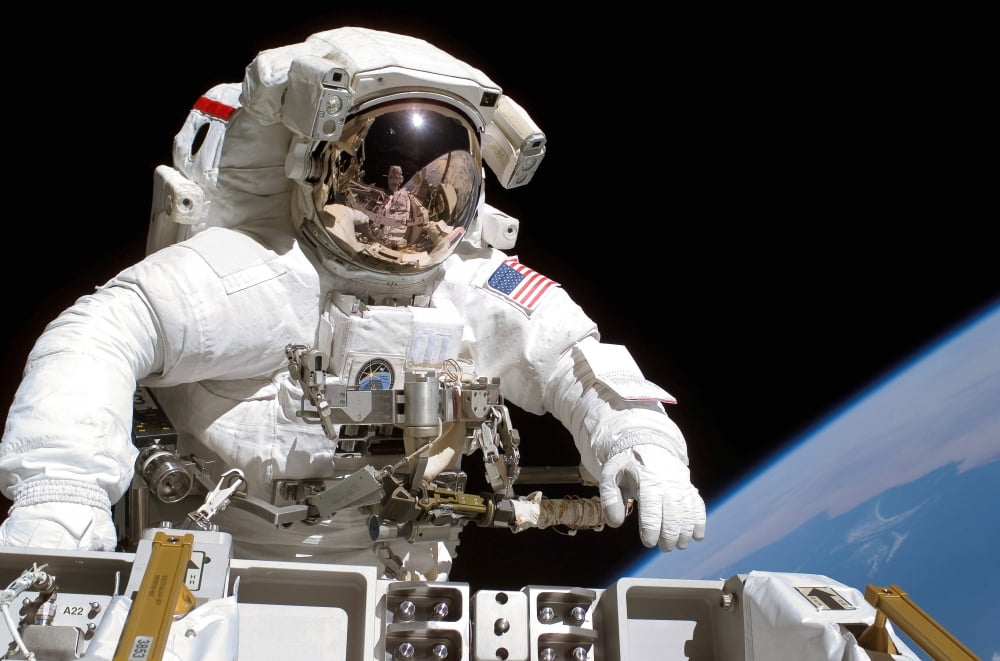 Astronaut participates in extravehicular activity Canvas Art - Stocktrek Images (34 x 23)