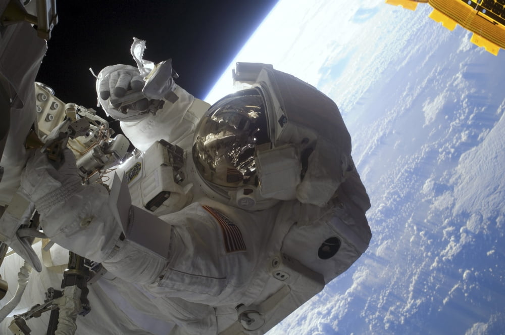 Astronaut participates in extravehicular activity Canvas Art - Stocktrek Images (34 x 23)