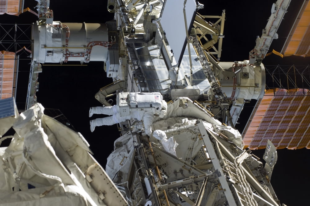 Astronaut participates in extravehicular activity Canvas Art - Stocktrek Images (34 x 23)