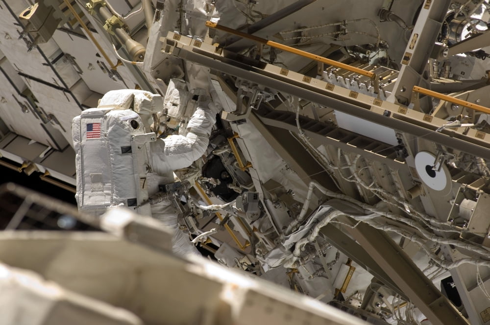 Astronaut participates in extravehicular activity Canvas Art - Stocktrek Images (34 x 23)