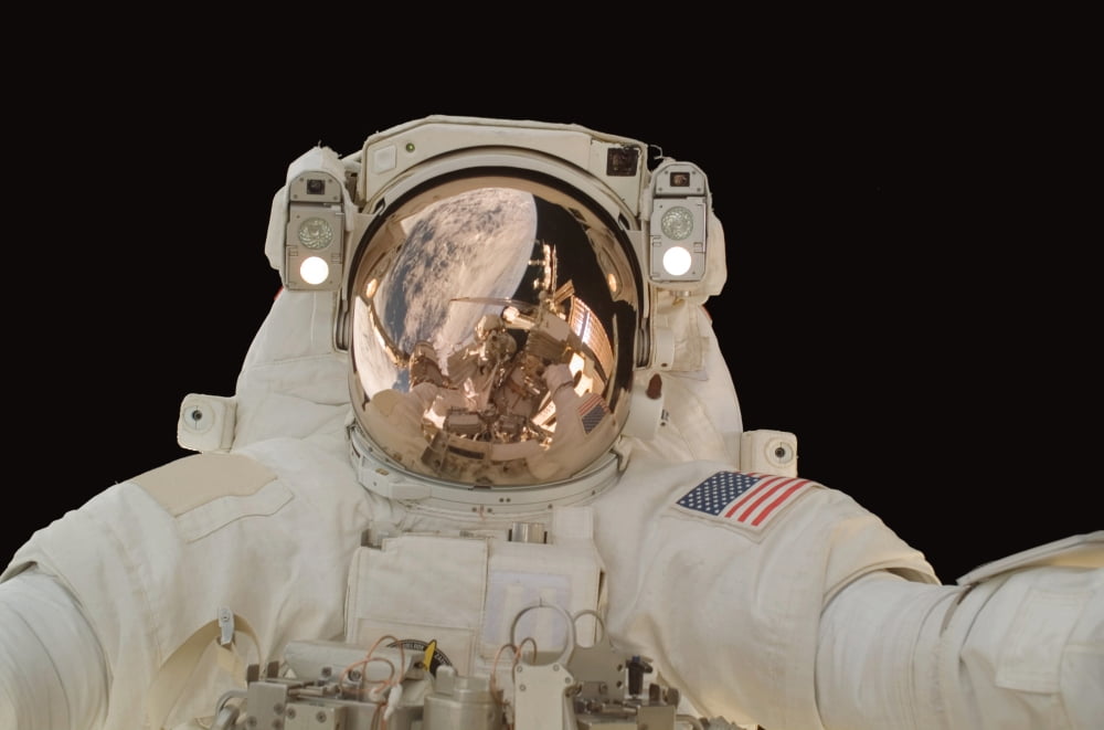Astronaut participates in extravehicular activity Canvas Art - Stocktrek Images (34 x 23)
