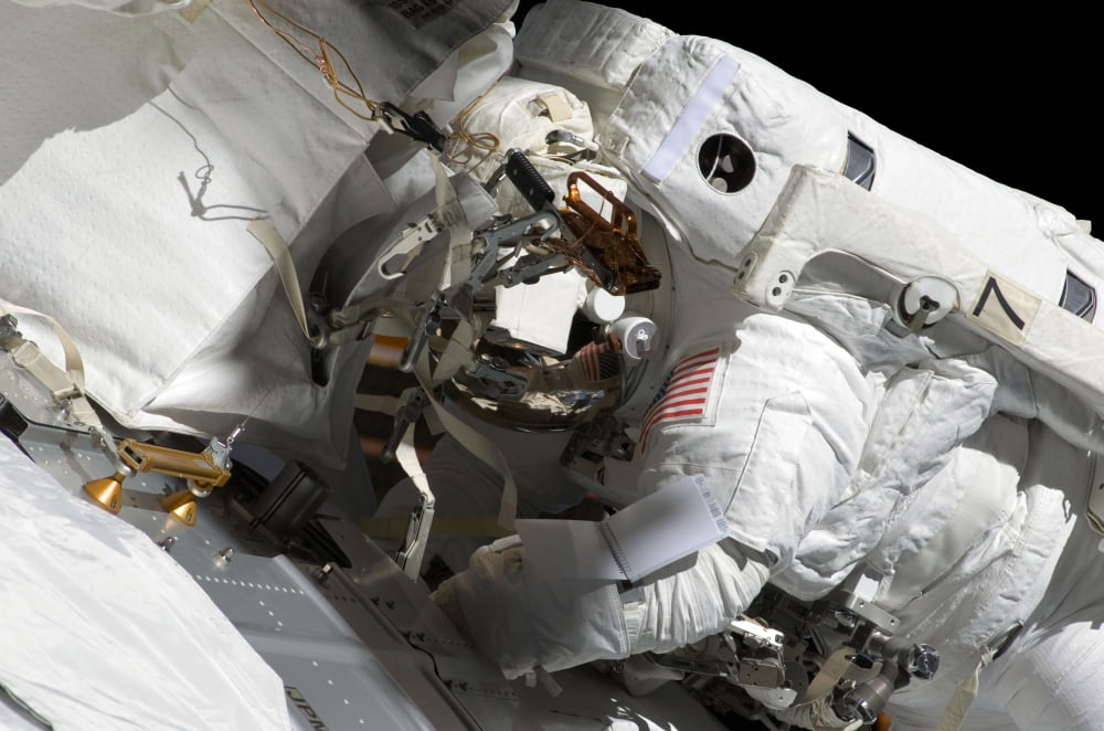 Astronaut participates in extravehicular activity Canvas Art - Stocktrek Images (34 x 23)