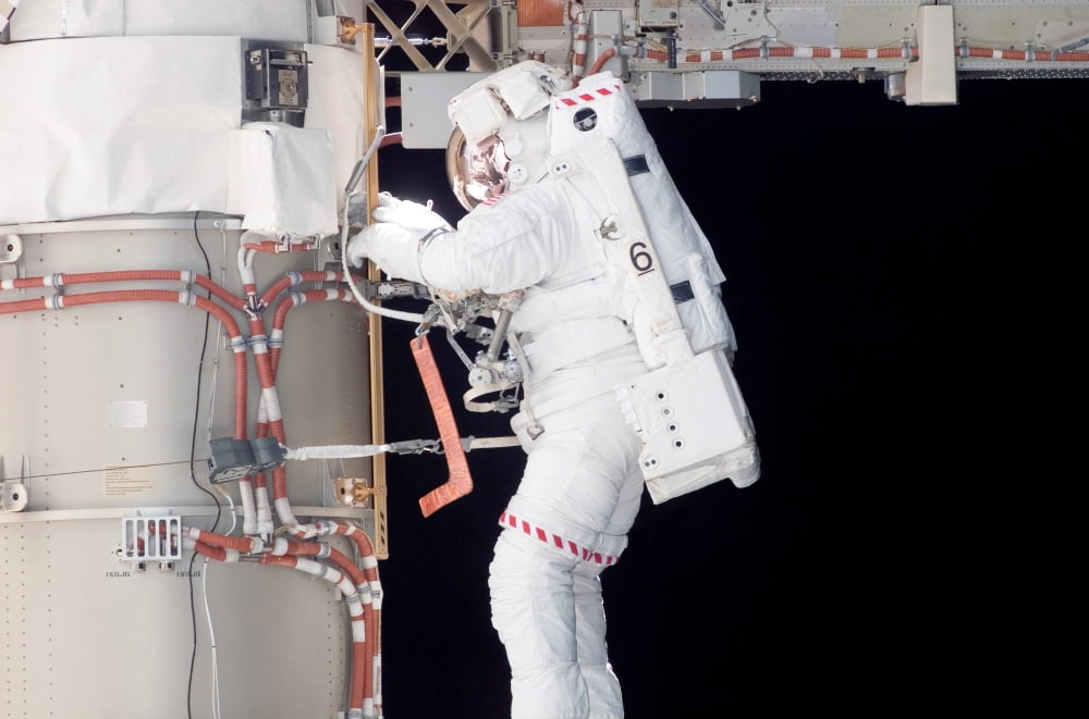 Astronaut participates in extravehicular activity Canvas Art - Stocktrek Images (34 x 23)