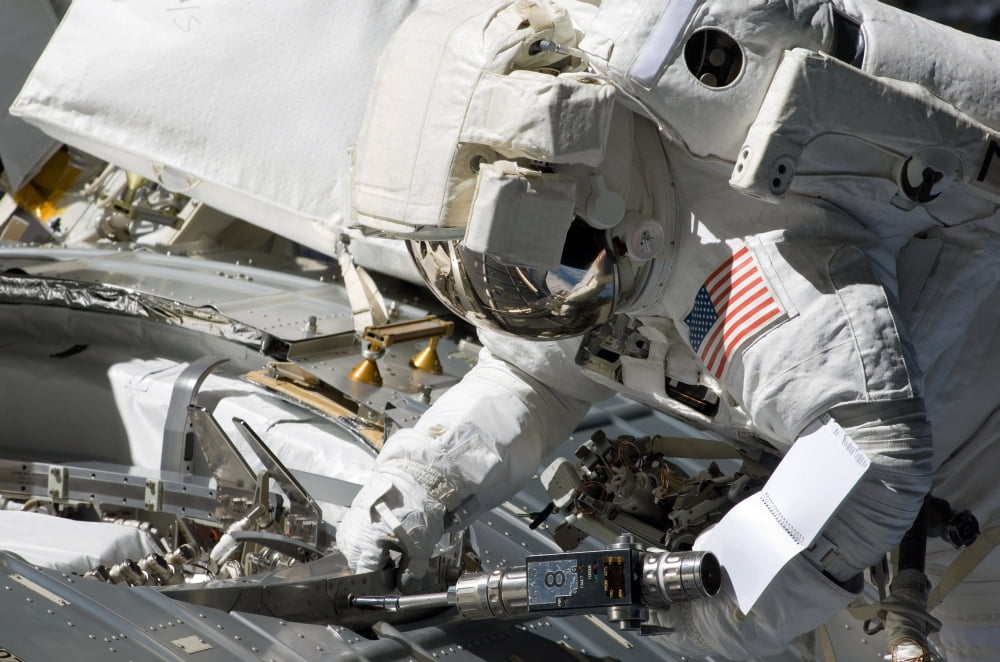 Astronaut participates in extravehicular activity Canvas Art - Stocktrek Images (34 x 23)