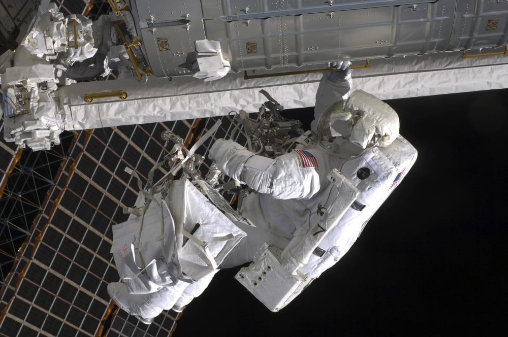 Astronaut participates in extravehicular activity Canvas Art - Stocktrek Images (35 x 23)