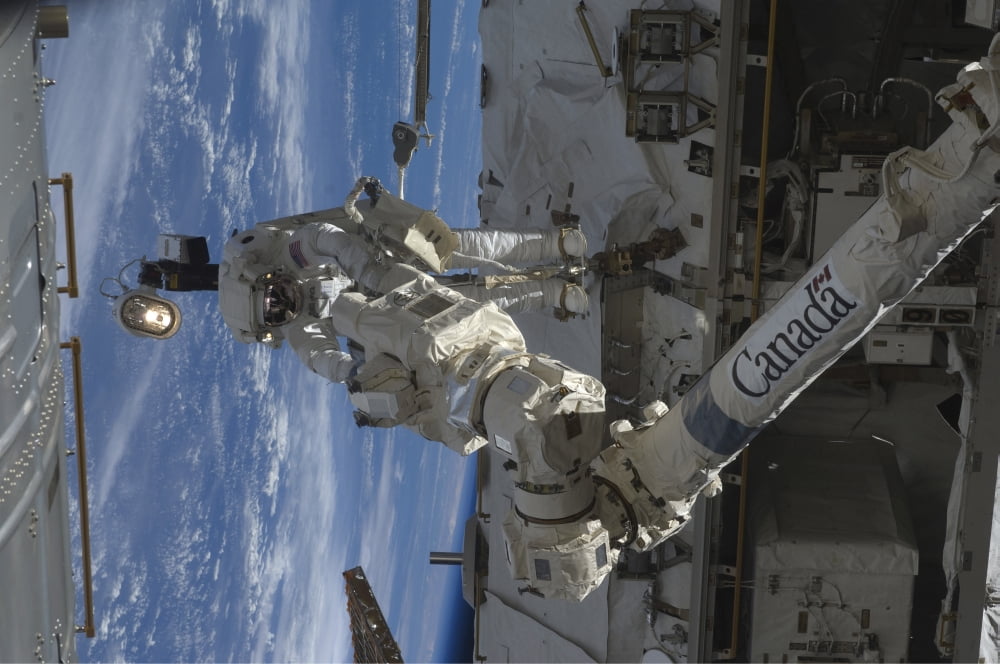 Astronaut participates in extravehicular activity Canvas Art - Stocktrek Images (35 x 23)
