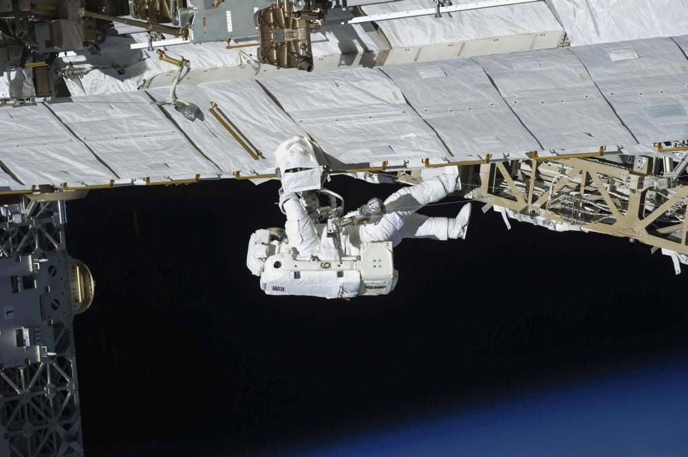 Astronaut participates in extravehicular activity Canvas Art - Stocktrek Images (35 x 23)