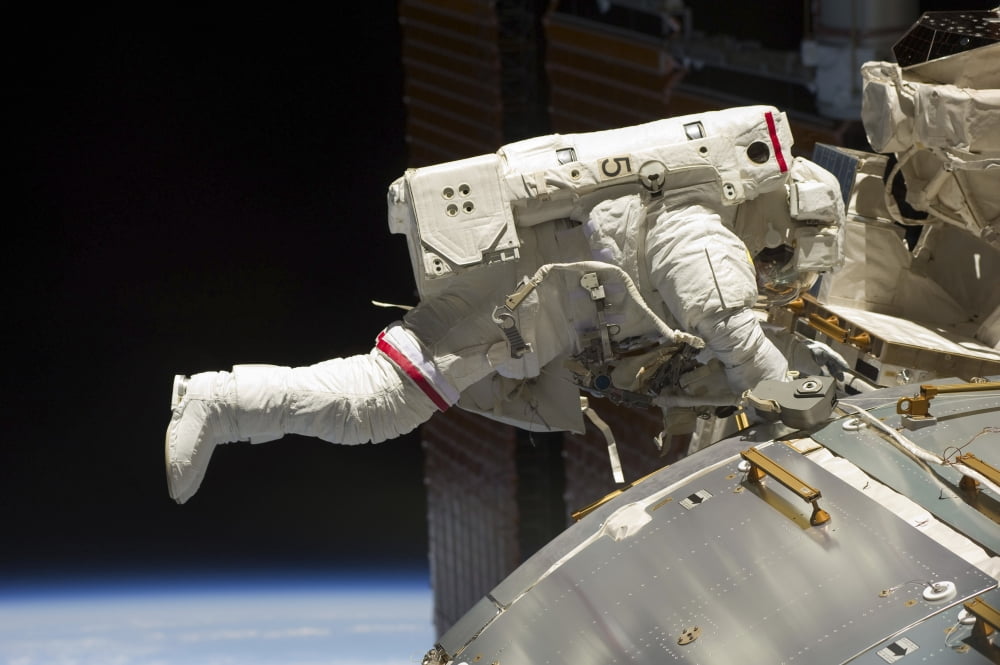 Astronaut participates in extravehicular activity Canvas Art - Stocktrek Images (35 x 23)