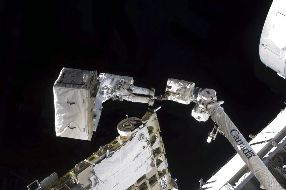 Astronaut participates in extravehicular activity Canvas Art - Stocktrek Images (35 x 23)