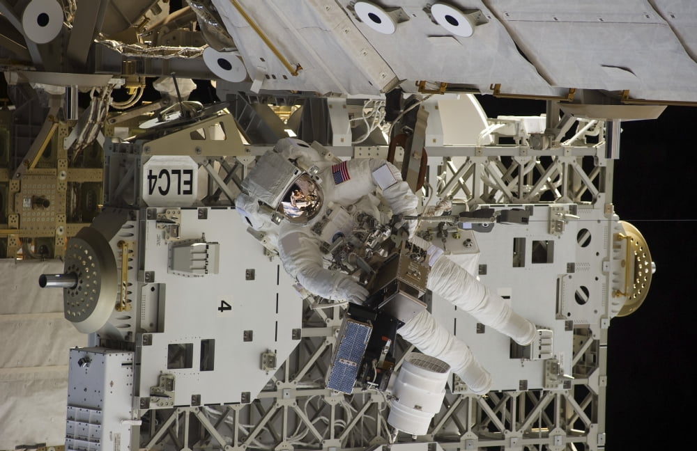 Astronaut participates in extravehicular activity Canvas Art - Stocktrek Images (35 x 23)