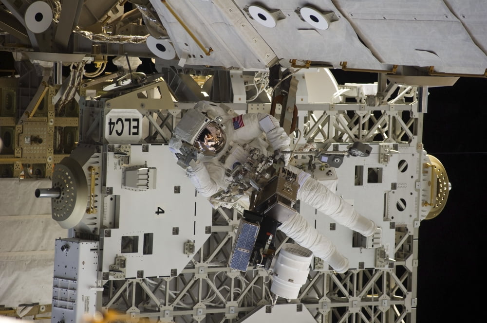 Astronaut participates in extravehicular activity Canvas Art - Stocktrek Images (35 x 23)