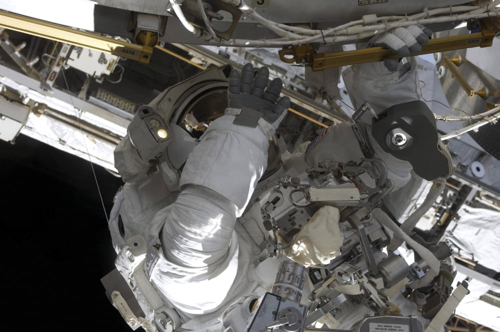 Astronaut participates in extravehicular activity Canvas Art - Stocktrek Images (35 x 23)