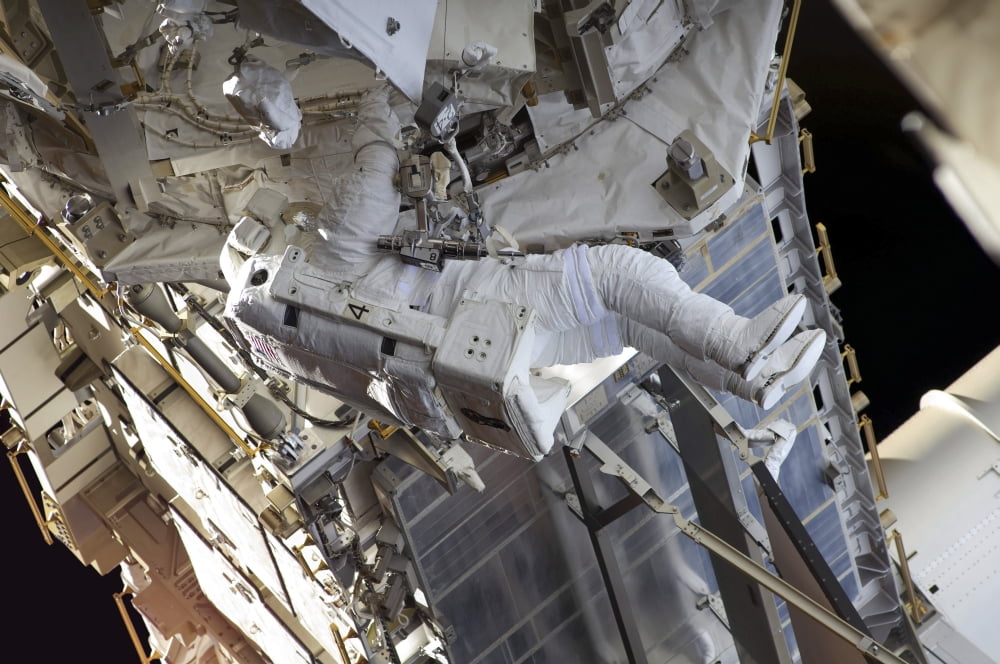 Astronaut participates in extravehicular activity Canvas Art - Stocktrek Images (35 x 23)