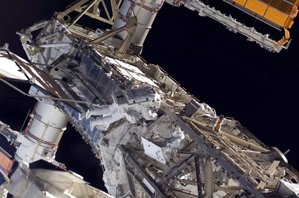 Astronaut participates in extravehicular activity Canvas Art - Stocktrek Images (35 x 23)