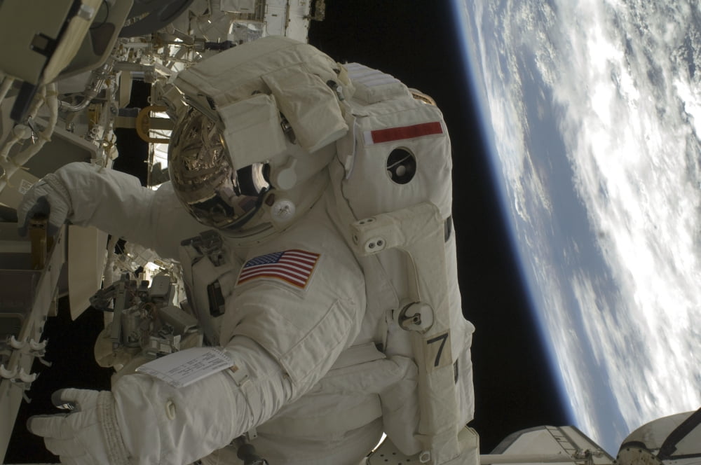 Astronaut participates in extravehicular activity Canvas Art - Stocktrek Images (35 x 23)