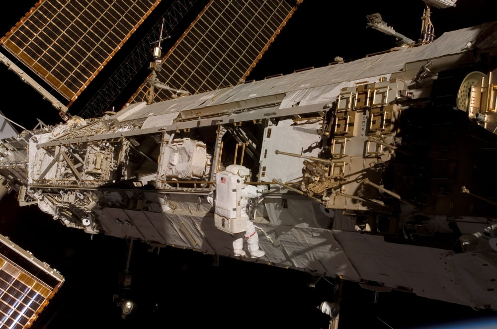 Astronaut participates in extravehicular activity on the International Space Station Canvas Art - Stocktrek Images (34 x 23)