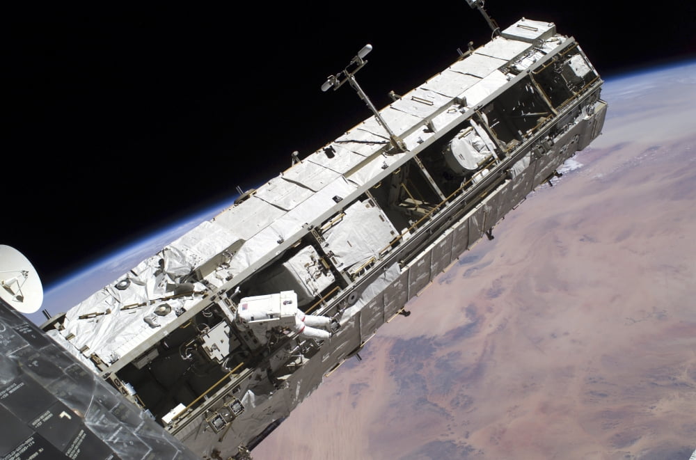 Astronaut participates in extravehicular activity on the International Space Station Canvas Art - Stocktrek Images (34 x 23)