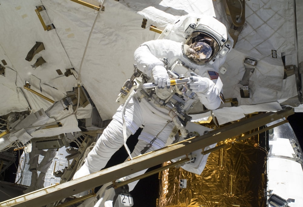 Astronaut participates in extravehicular activity on the International Space Station Canvas Art - Stocktrek Images (34 x 24)