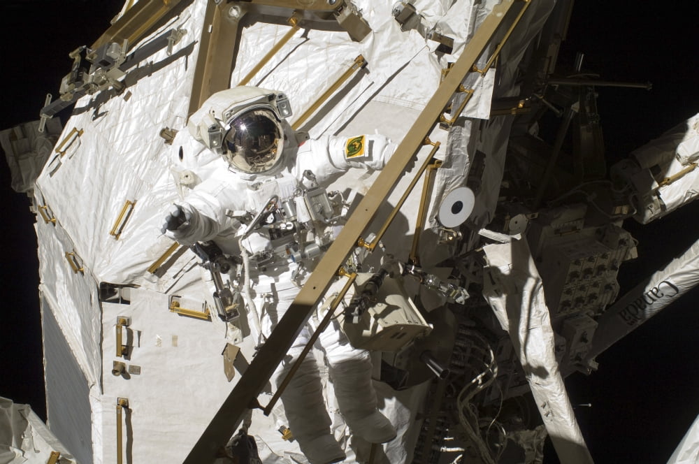 Astronaut participatse in a session of extravehicular activity Canvas Art - Stocktrek Images (34 x 23)