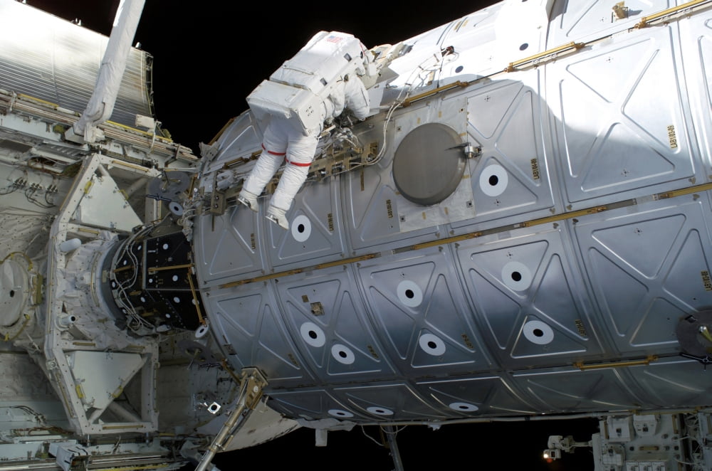 Astronaut traverses along the Destiny laboratory of the International Space Station Canvas Art - Stocktrek Images (34 x 23)