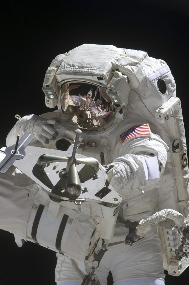 Astronaut uses a digital still camera during a spacewalk Canvas Art - Stocktrek Images (23 x 34)