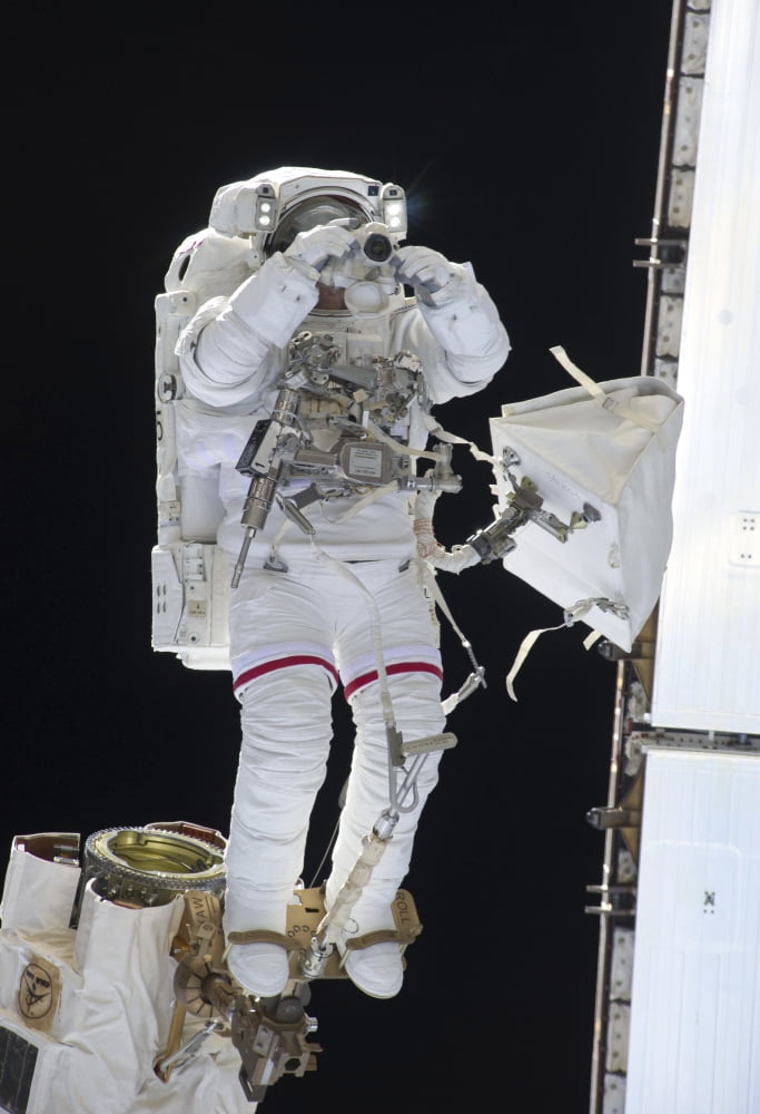 Astronaut uses a digital still camera during a spacewalk Canvas Art - Stocktrek Images (24 x 34)
