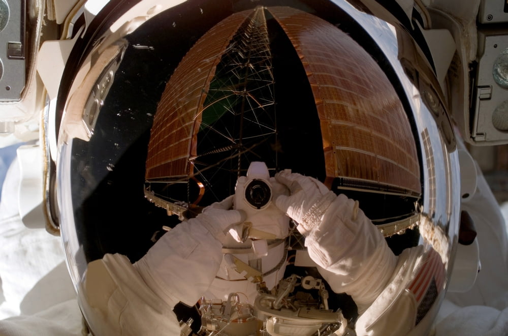 Astronaut uses a digital still camera to expose a photo of her helmet visor during a spacewalk Canvas Art - Stocktrek Images (34 x 23)