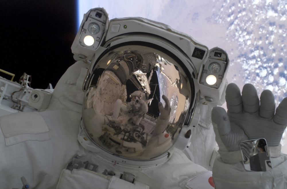Astronaut waves at his space-walking crewmate Canvas Art - Stocktrek Images (34 x 23)