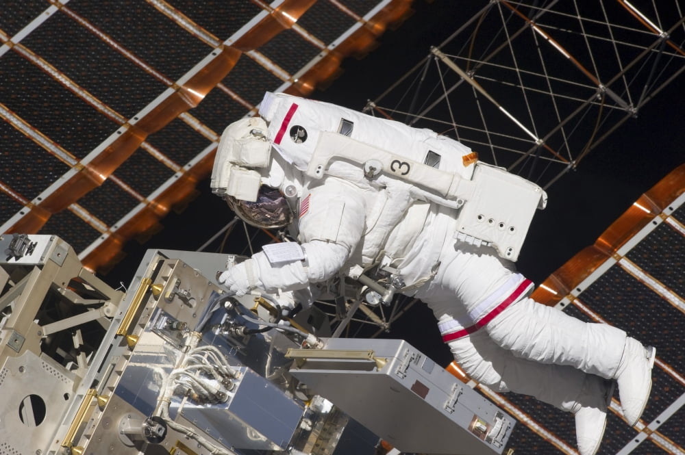 Astronaut working on part of the International Space Station Canvas Art - Stocktrek Images (34 x 23)