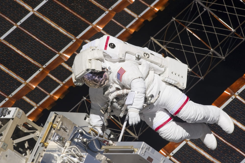 Astronaut working on part of the International Space Station Canvas Art - Stocktrek Images (34 x 23)