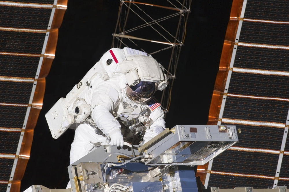 Astronaut working on part of the International Space Station Canvas Art - Stocktrek Images (34 x 23)
