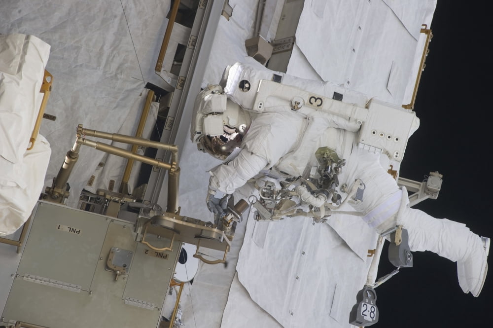 Astronaut working on part of the International Space Station Canvas Art - Stocktrek Images (34 x 23)