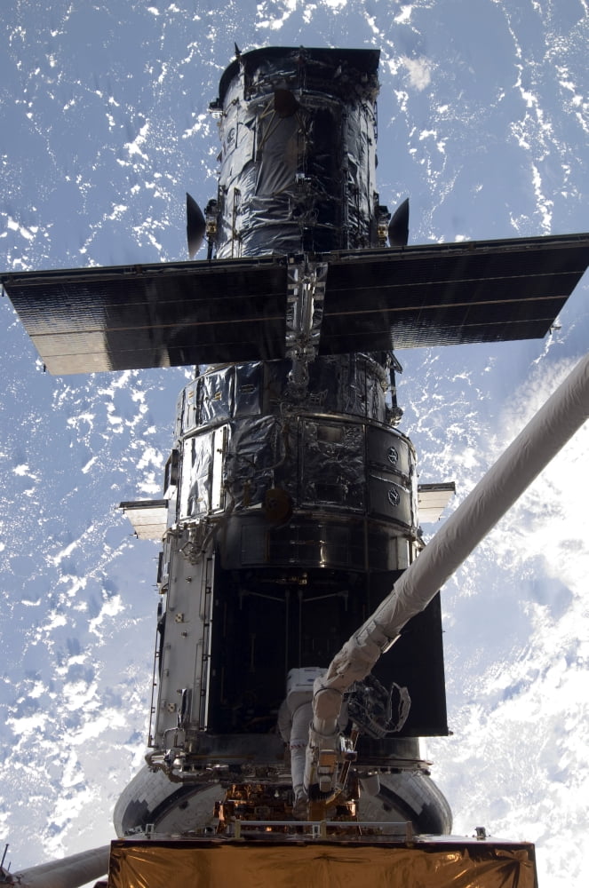Astronaut working on the Hubble Space Telescope during a spacewalk Canvas Art - Stocktrek Images (23 x 34)