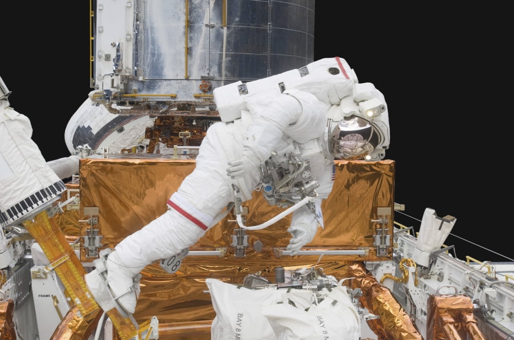 Astronaut working on the Hubble Space Telescope during a spacewalk Canvas Art - Stocktrek Images (34 x 23)