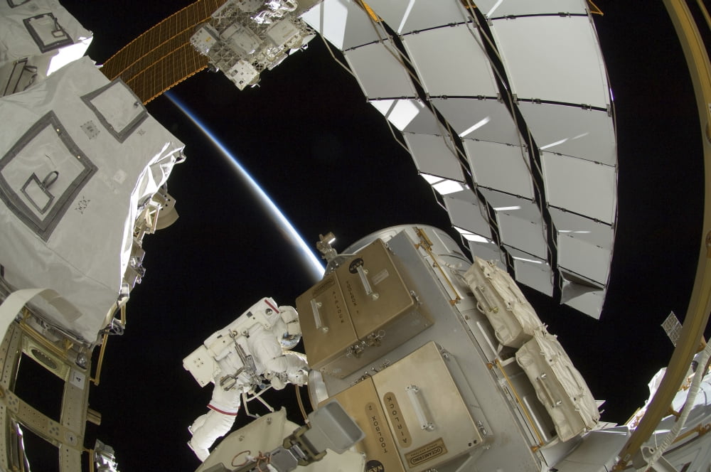 Astronaut working on the International Space Station Canvas Art - Stocktrek Images (34 x 23)