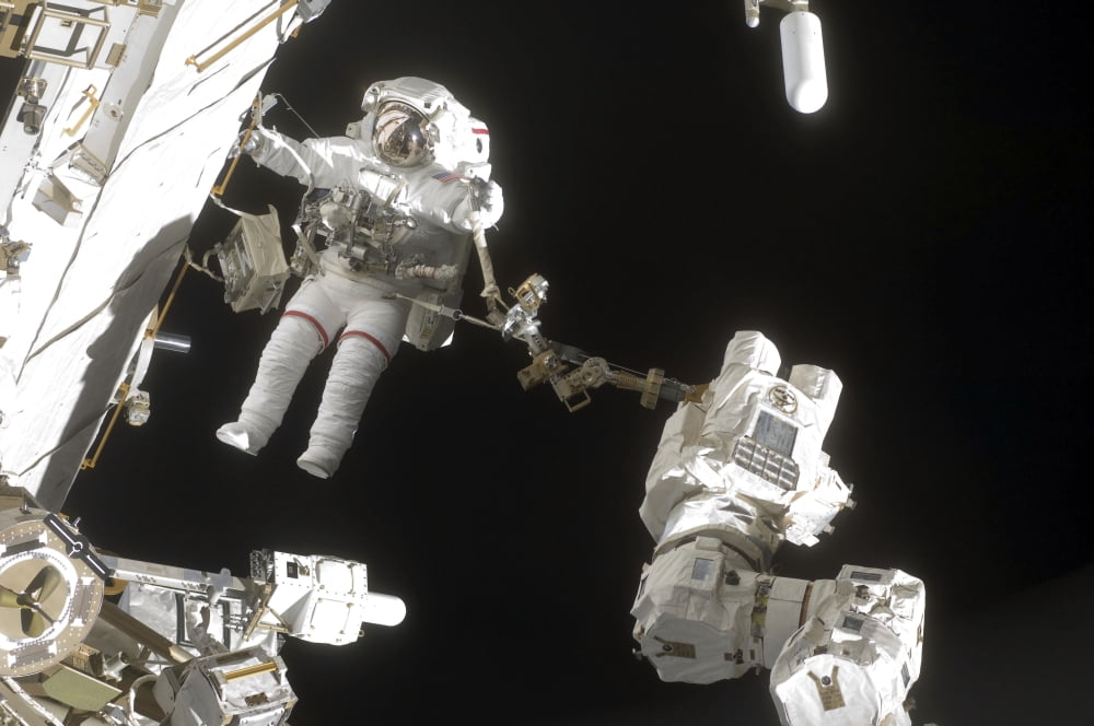 Astronaut working on the International Space Station during a spacewalk Canvas Art - Stocktrek Images (34 x 23)